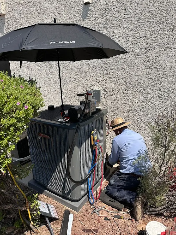 HVAC technician performing outdoor AC maintenance in Edgewood