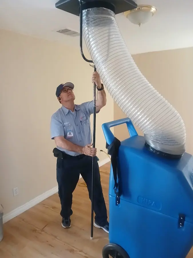 Furnace Tune-Up technician using HEPA equipment in Edgewood